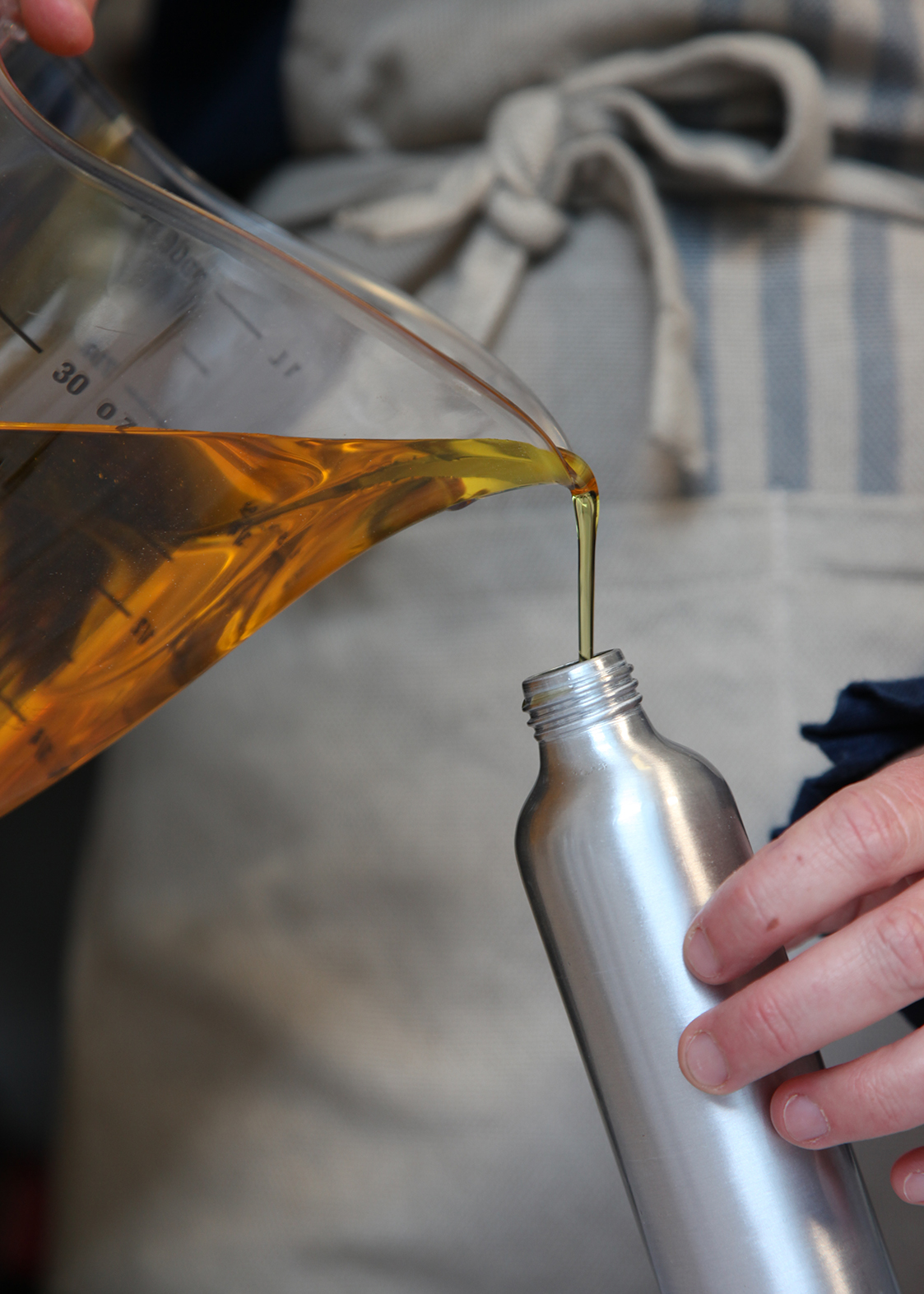 Ella, founder of Phoenix & Providence, filling bottles with organic seaweed skincare.